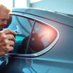Enhance your view with window tint Chattanooga by a skilled technician applying tint on a modern vehicle.